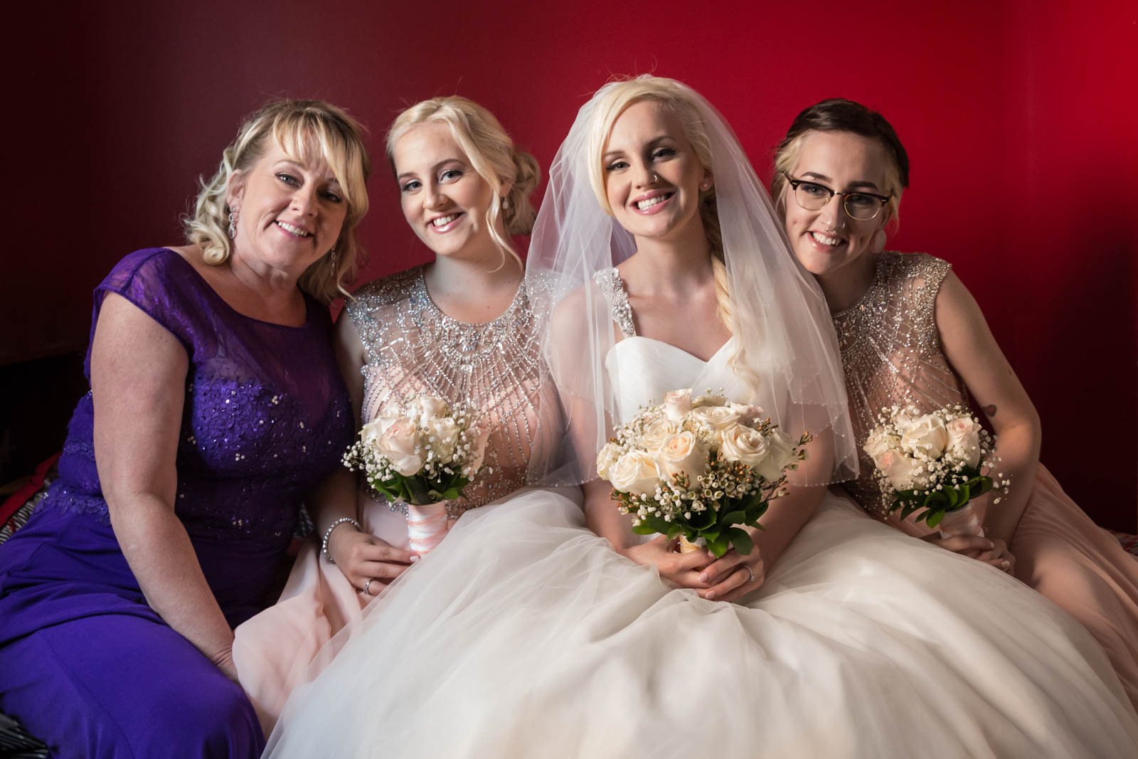 Bride with bridesmaids and mom